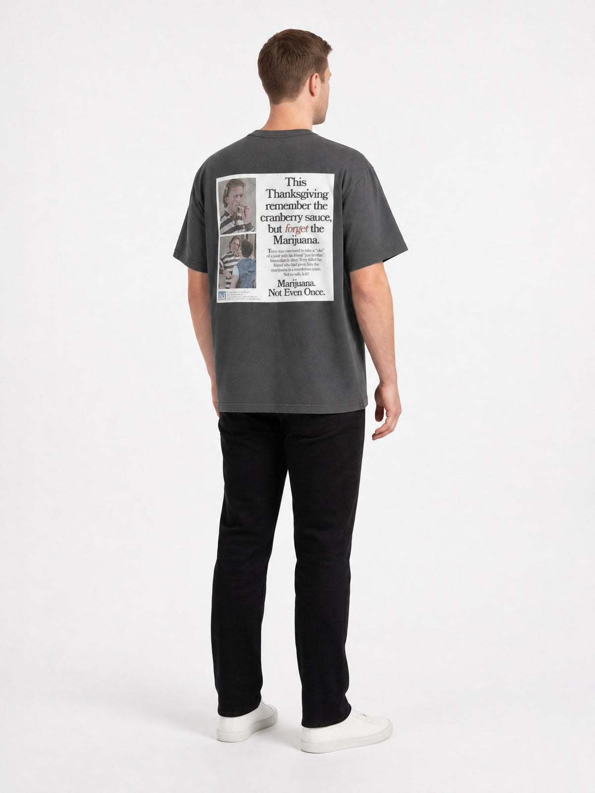 AI-generated model, no real person pictured. Happy Thanksgiving oversized faded tee in faded black, three-quarter back view.