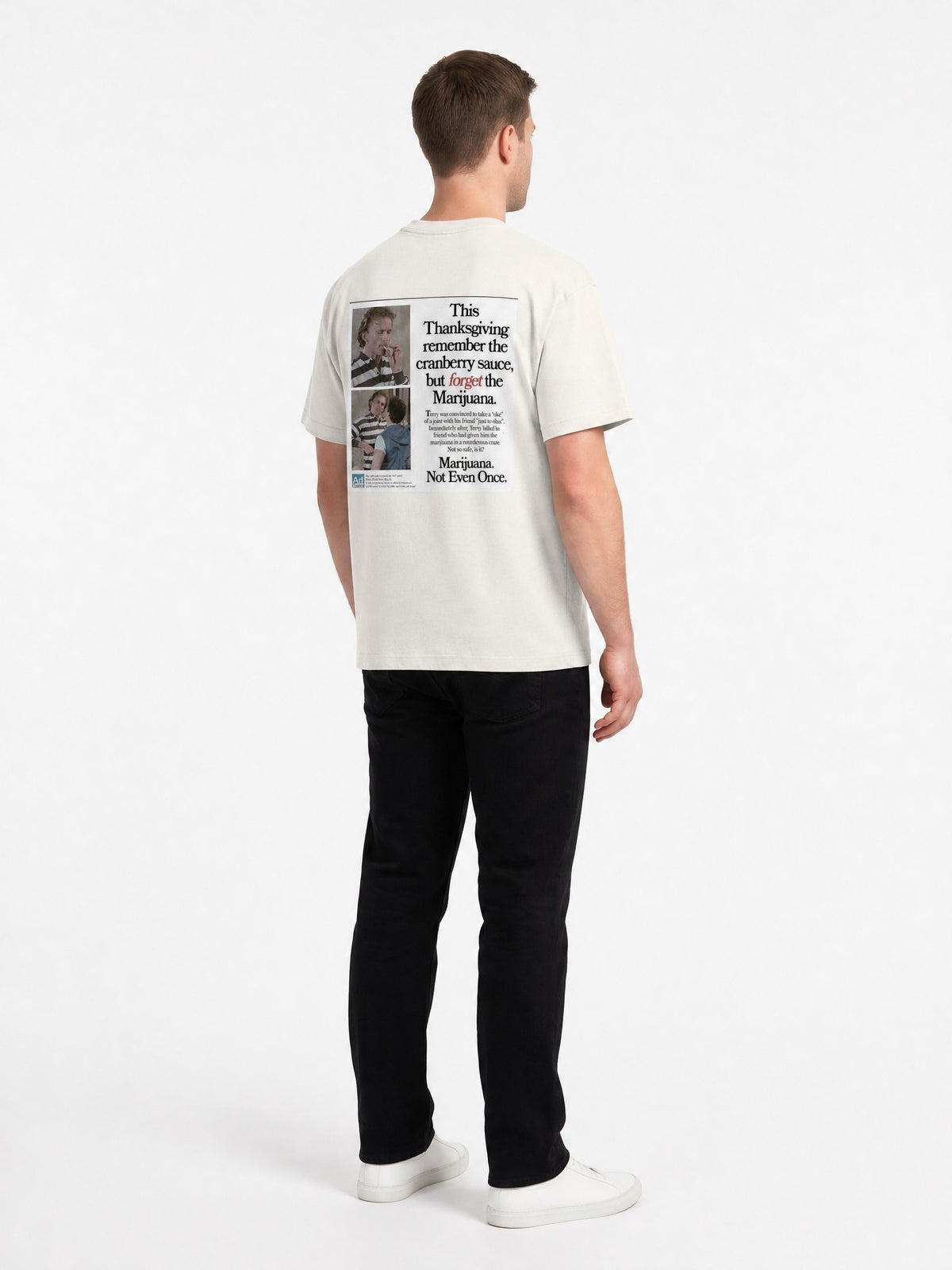 AI-generated model, no real person pictured. Happy Thanksgiving oversized faded tee in faded bone, three-quarter back view.