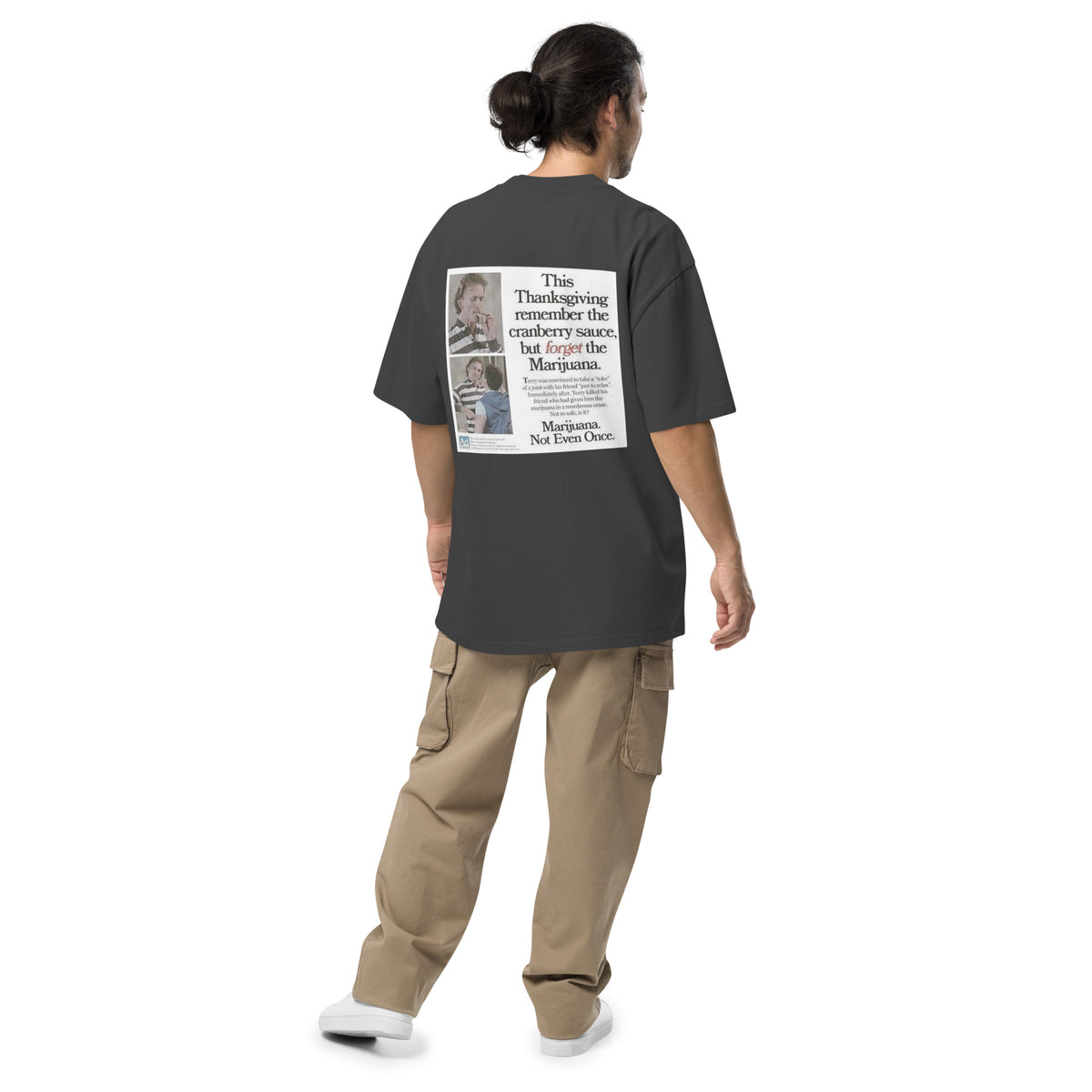 Happy Thanksgiving oversized faded tee in faded black, back view on a men's studio model (Printful mockup)