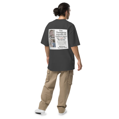 Happy Thanksgiving oversized faded tee in faded black, back view on a men's studio model (Printful mockup)