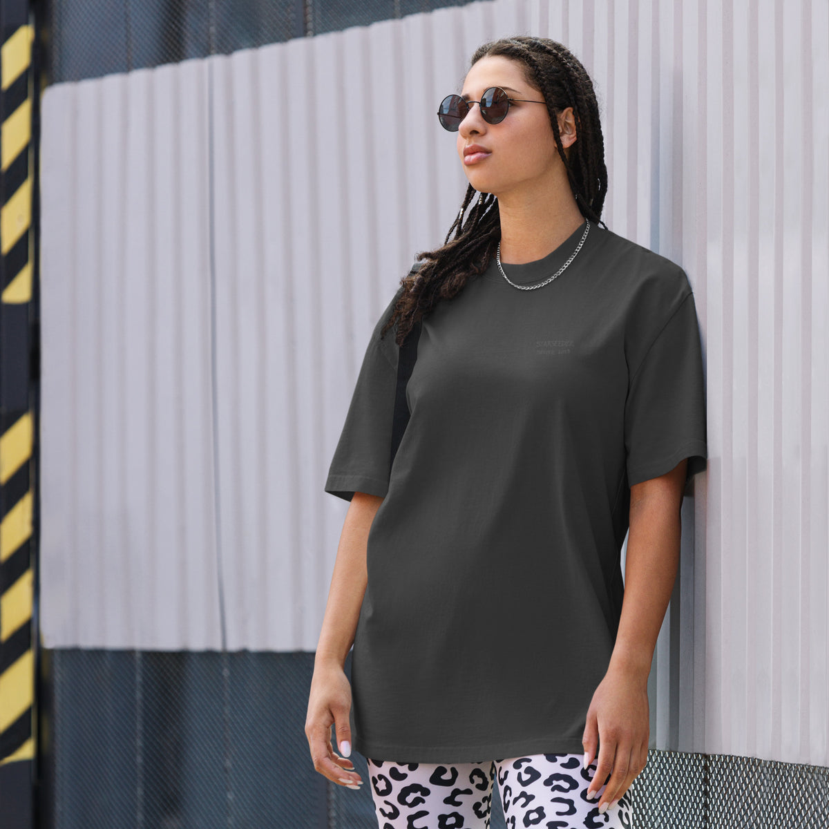 Not Even Once oversized faded tee in faded black, front view on a women's lifestyle model (Printful mockup)