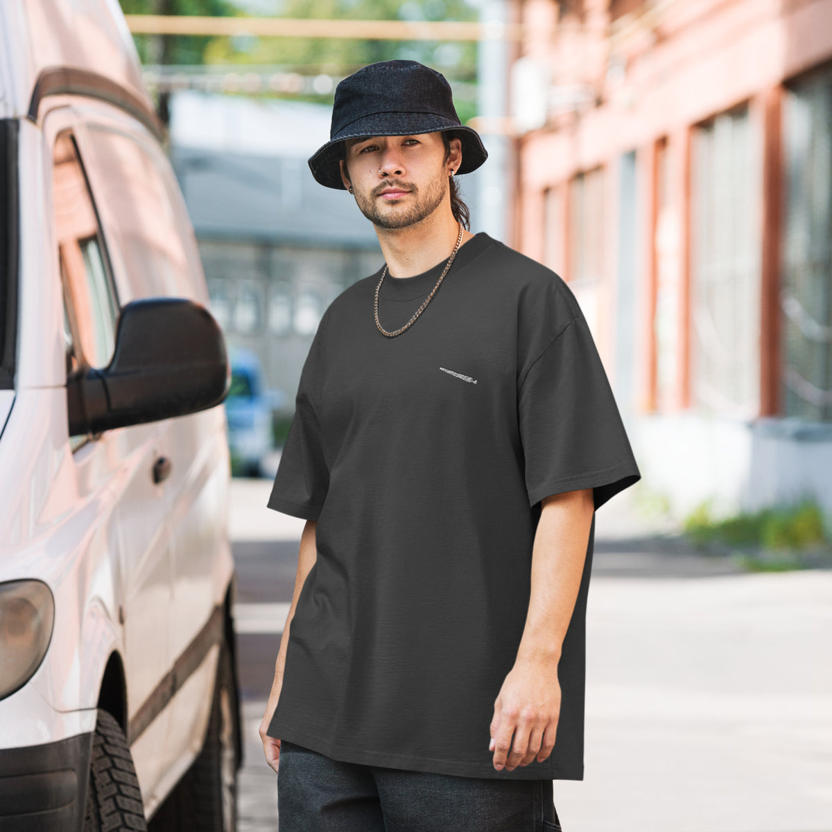 H?rd Day oversized faded tee in faded black, front view on a men's lifestyle model (Printful mockup)
