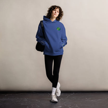 Mickey Money '22 unisex oversized hoodie in cobalt, front view on a women's lifestyle model (Printful mockup)